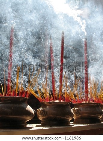 Burning prayer sticks fill the room with swirling smoke.  Thien Hau Pagoda, Cholon (China Town), Ho Chi Minh, Vietnam.