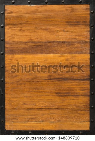 back metal frame with light brown row wood background