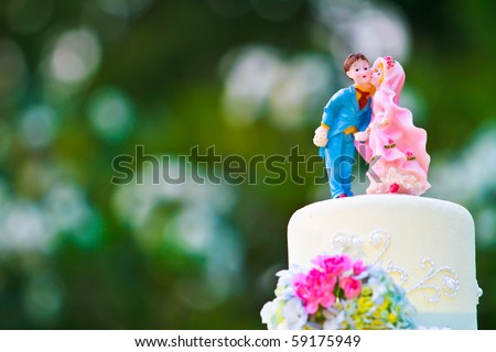 stock photo Bride and Groom cake toppers on a wedding cake