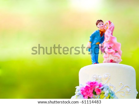 stock photo Bride and Groom cake toppers on a wedding cake