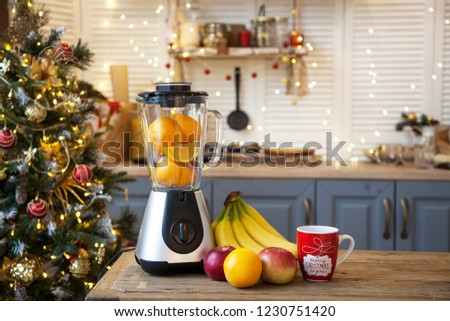 Christmas in the kitchen.Blender with fruit on the table