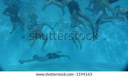 swimmers underwater in pool