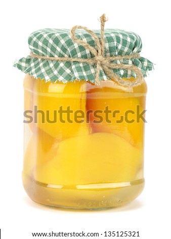 Jar of canned peaches on a white background
