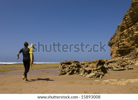 surfer running in the beach