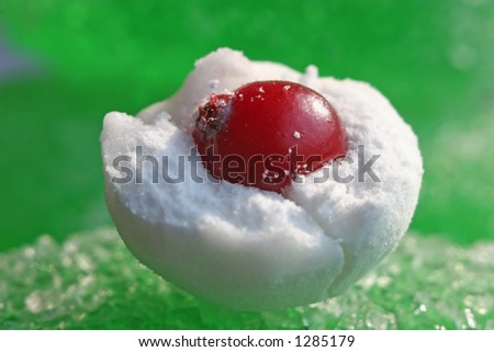 Cranberry in powdered sugar on a background of fruit candy. Super Macro