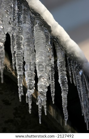 The icicles which are hanging down from a roof at home