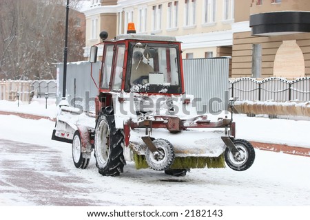 After a strong snow storm the snow-removing machine cleans streets