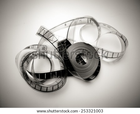 Unrolled 35mm movie reel in vintage black and white and light effect