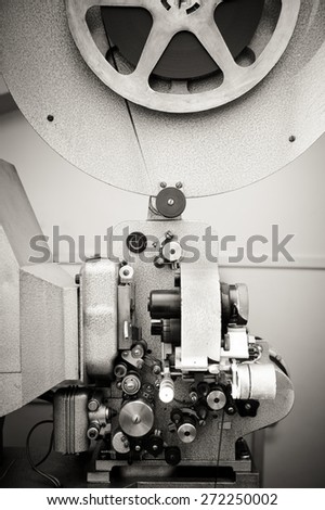 Cinema projector for 16 mm movie, old vintage  professional industrial machine with reel in black and white