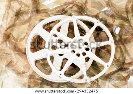 Couple of cinema movie reels and 35 mm unrolled filmstrip background