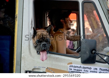 ROME, ITALY - JUNE 24 2006. Gay pride day, parade people on city streets during the demonstration. Truck driver and a dog inside float