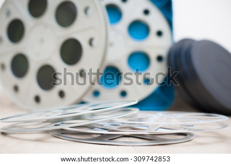 Empty cinema movie reel with boxes out of focus in background