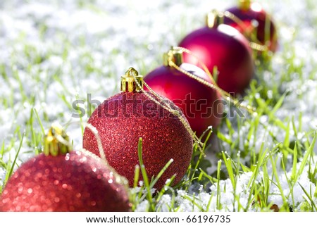 row of Christmas balls with snow focus on second  ball