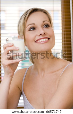 Lifestyle model holding a milk beside her face