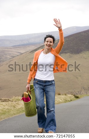 happy woman going to picnic and saying hello