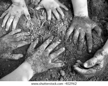 Children\'s hands in dirt.