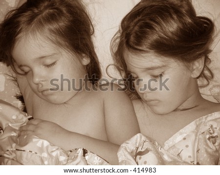stock photo Two little girls sleeping in one bed