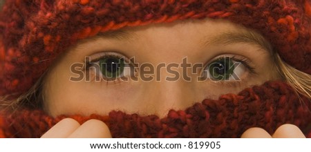 Pretty little girl wearing a red knit hat and matching scarf.