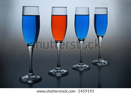 Wineglasses filled with colored liquid - illustrating concepts such as Workplace Diversity, Dare to be Different, or Democrat vs Republican.