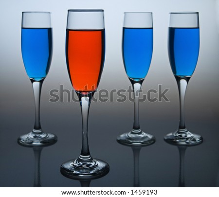 Wineglasses filled with colored liquid - illustrating concepts such as Workplace Diversity, Democrat versus Republican, or Dare to be Different.
