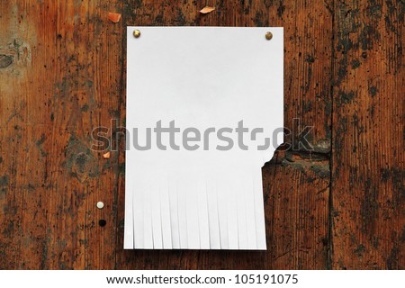 for your notice: clear white paper with cut slips for phone number on the wood bulletin board