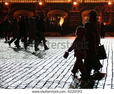 Walking people at the night cobble-stone road (Red square, Moscow, Russia).
