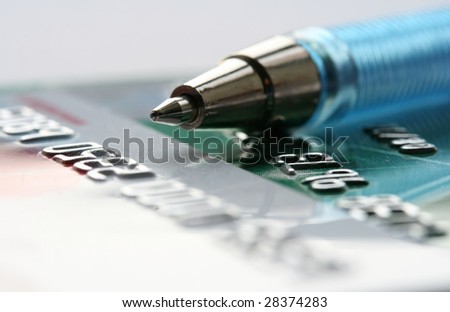 Close-up of pen and plastic cards as a background