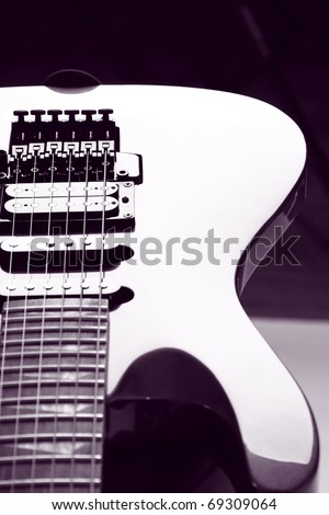 Close-up of electric guitar body. Strings and string pickups (a humbucker pickup and two single-coil pickups)