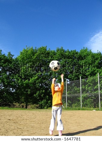girl throw football up to sky