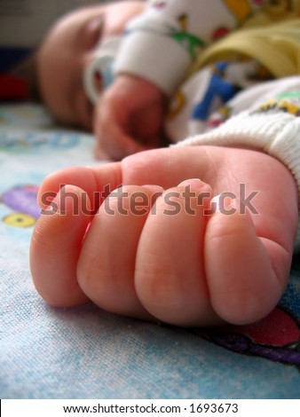 baby hand;  baby sweet dream on colourful blanket;
