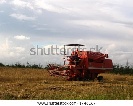 Combine harvester mow cereal. Harvest finishing. All logos have been removed.