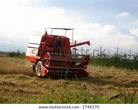 Combine harvester mow cereal. Harvest finishing. All logos have been removed.
