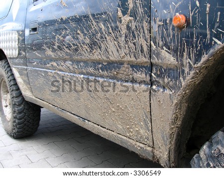 dirty car after race,  see mud on one side