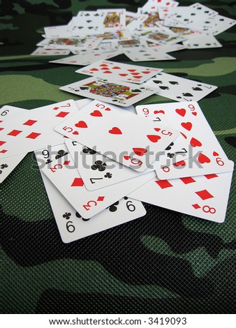 cards texture on the camouflage pattern,  scattered cards, deck of cards background,