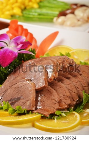 Sliced braised beef shank Served with lemon and  flower
