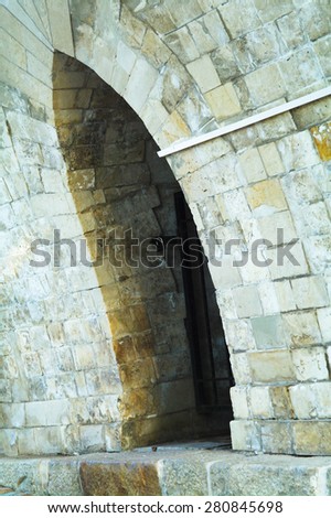 The arch shape of the bridge of a large complex of the Tsaritsyno Palace in Tsaritsino park, city of Moscow, in the summer, day
