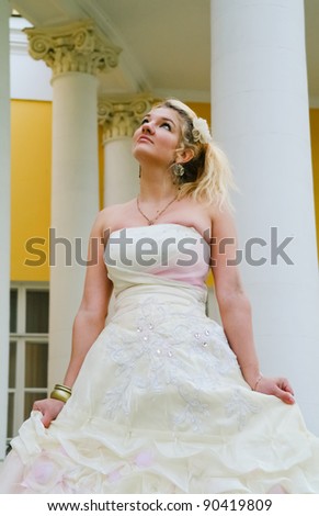 Blonde girl in the image of a medieval lady in a gorgeous dress of the old manor near Moscow