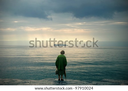 Old woman watching the sea