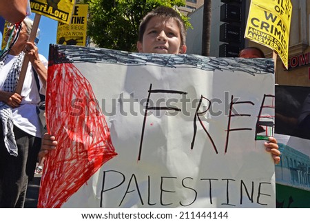 HOLLYWOOD, CA - AUGUST 16, 2014: A young boy holds a handmade protest sign which reads, \