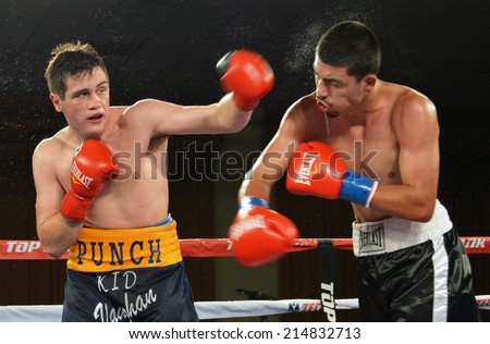 GLENDALE, CA - AUGUST 9, 2014: :Boxer Liam Vaughn follows through on a punch against his opponent Saul Benitez. The bout took place at Glendale Fight Night in Glendale, California on August 9, 2014.
