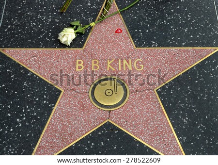 HOLLYWOOD, CA -MAY 16, 2015: A flower left by a fan rests on B.B.King\'s star on the Hollywood Walk of Fame on May 16, 2015 in Hollywood, California.