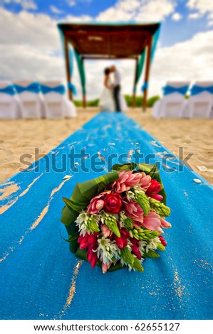 stock photo mexico beach wedding with bouquet in the foreground