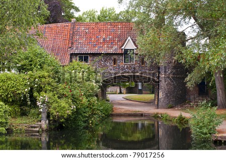the 15th century arch of Pulls Ferry in the english city of norwich alongside the river yare