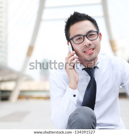 Asia business man using a mobile phone with copyspace