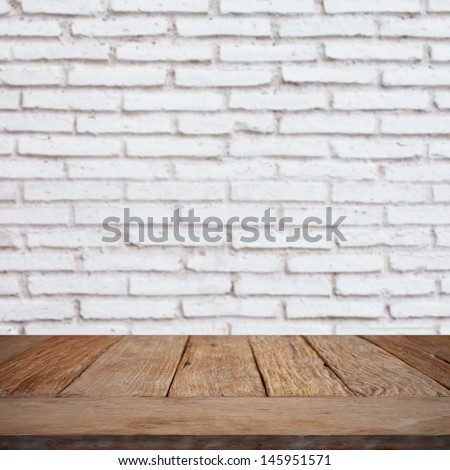 Wooden empty table with brick wall