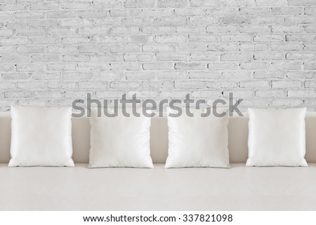 White square pillow on white sofa
