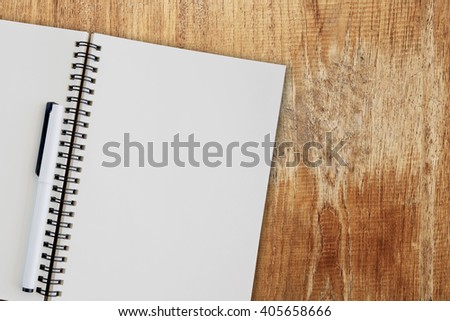 Blank notepad on wooden table.