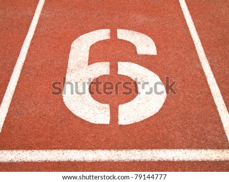 Number six on the start of a running track