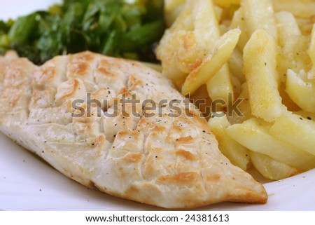 Fried chicken breast with potato chips and asparagus
