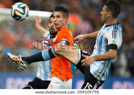 SAO PAULO,BRAZIL - July 9, 2014: DEMICHELIS of Argentina and VAN PERSIE of Netherlands compete for the ball during the World Cup Semi-finals game between Netherlands and Argentina at Arena Corinthians